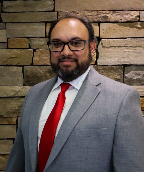 Cody Lawson, founder of Ascendancy HazLoc, in a gray suit and red tie